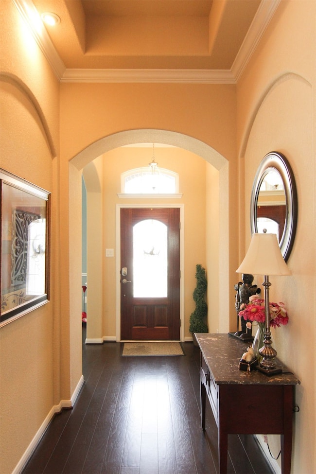 elegant foyer with tray ceiling; leaded glass fron
