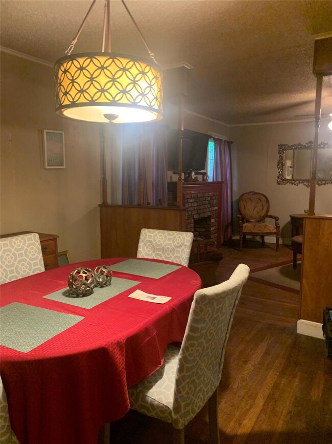 Dining space featuring a brick fireplace, a textur