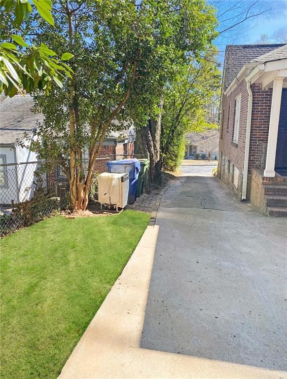 View of yard featuring fence