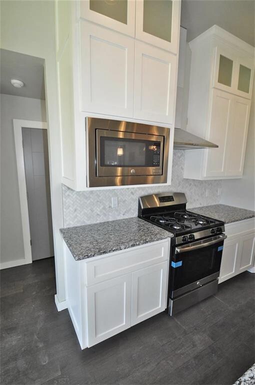 Kitchen  Stainless steel appliances and a trendy b