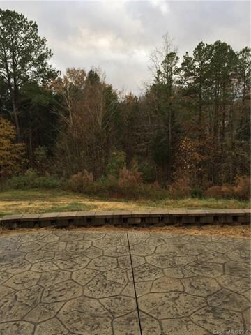 stamped concrete patio w view of woods