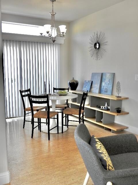 Behind the vertical blinds is a cozy balcony