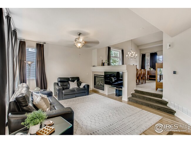 Step down family room with fireplace, high ceilings, and lots of space