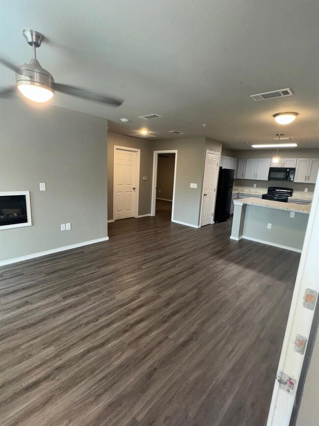Kitchen with dark wood-style floors, light counter