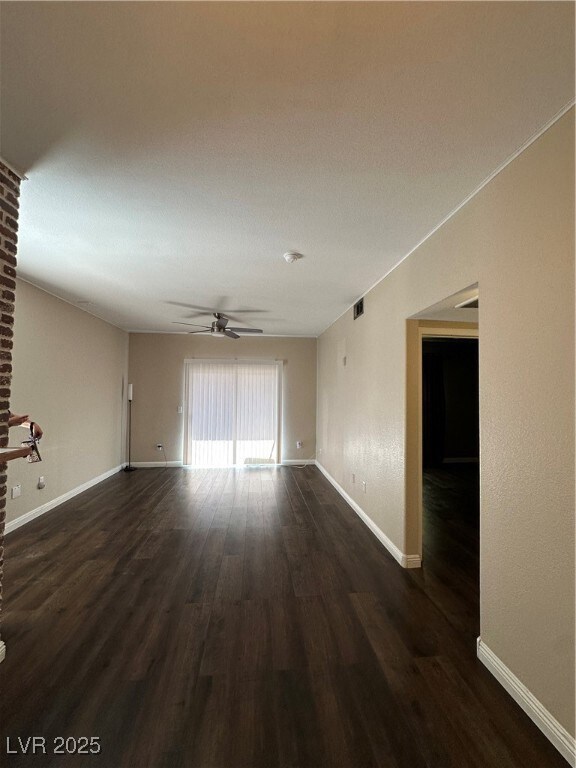 Unfurnished room with dark wood-type flooring and