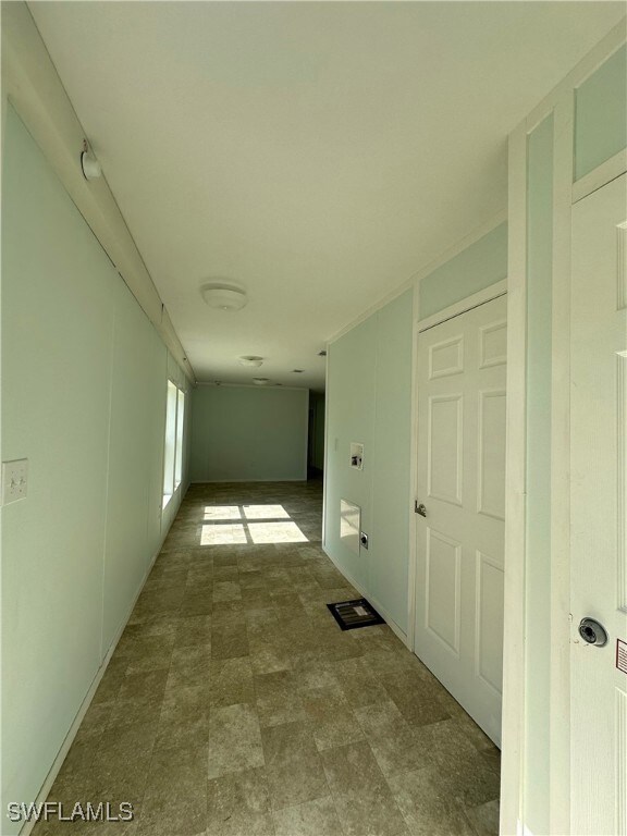 Hallway with tile patterned flooring