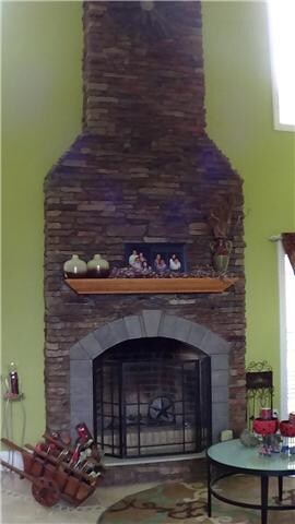 Stone fireplace reaches from floor to ceiling.  Wood or gas! 