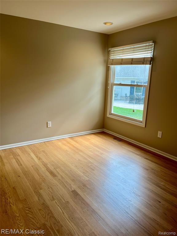 Spare room with light wood finished floors and baseboards