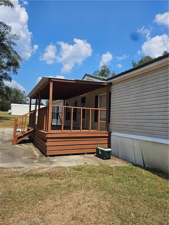 Front side view of house with a lawn and a deck