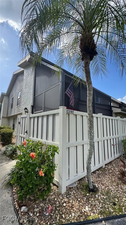 View of property exterior with a fenced front yard and stucco siding
