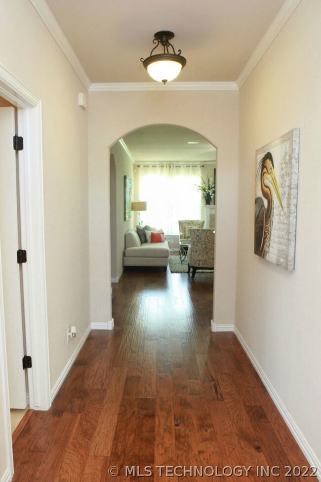 Front entry with crown molding, arched doorway and