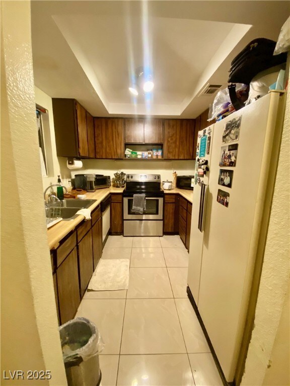 Kitchen with stainless steel electric range oven,