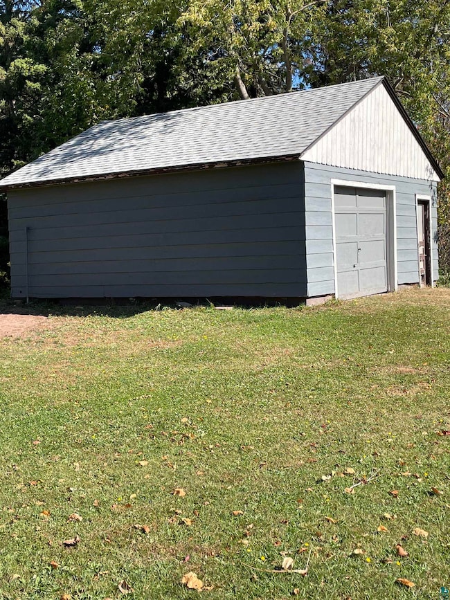Garage with a lawn and wooden walls