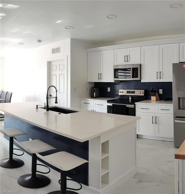 Kitchen with appliances with stainless steel finis