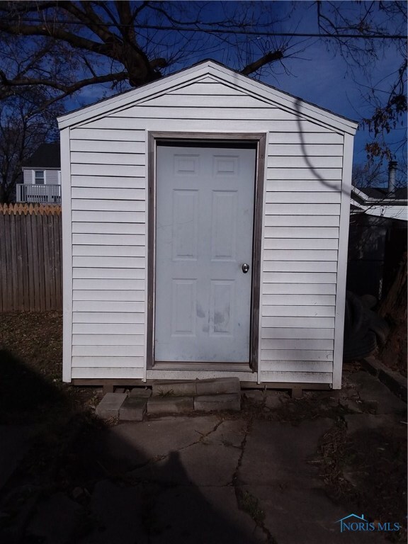 SHED WITH NEWER SIDING & DOOR.