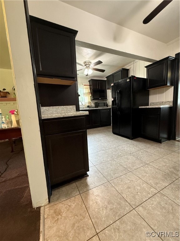 Kitchen with fridge, ceiling fan, light tile patte