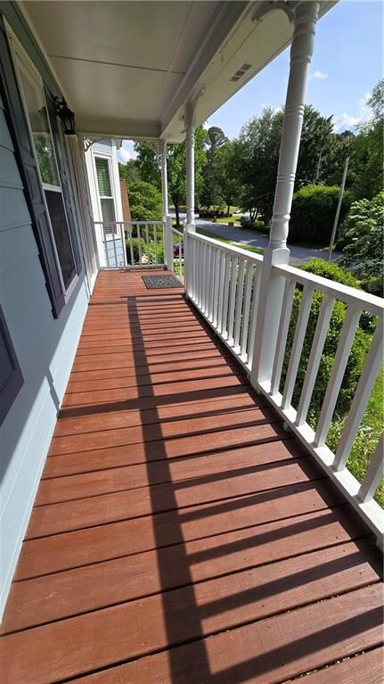 Wooden terrace featuring a porch