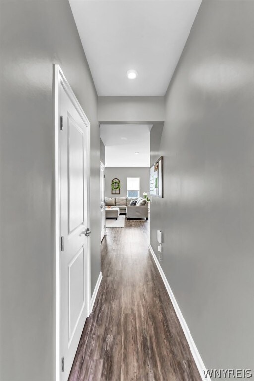 Hallway to living room, kitchen and half-bath.