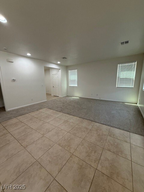 Empty room featuring light carpet, healthy amount