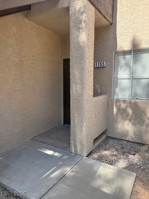 Property entrance with stucco siding