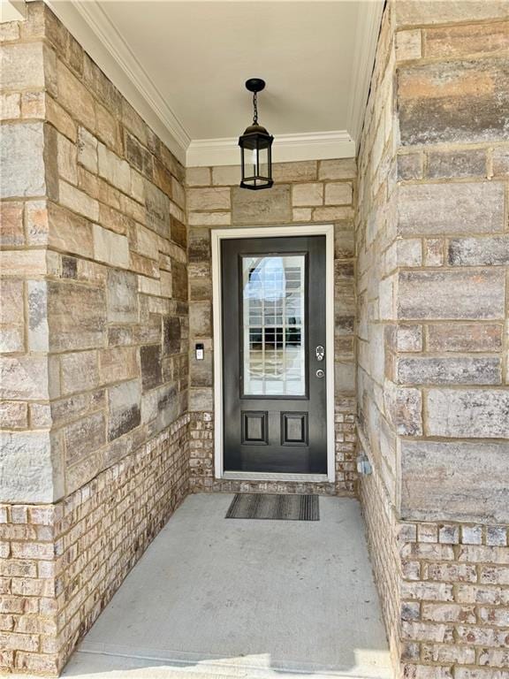 Doorway to property featuring stone siding