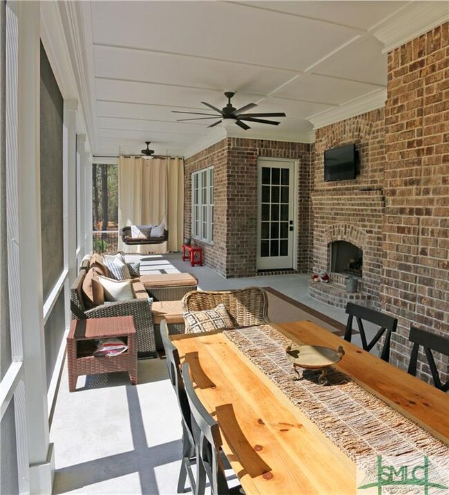 Screened in porch with fireplace and TV