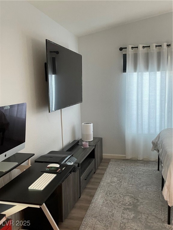 Bedroom with light wood-type flooring and a desk