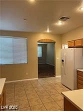 Kitchen with light tile patterned floors, visible