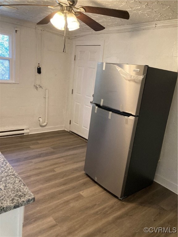 Kitchen with white cabinets, a baseboard radiator,