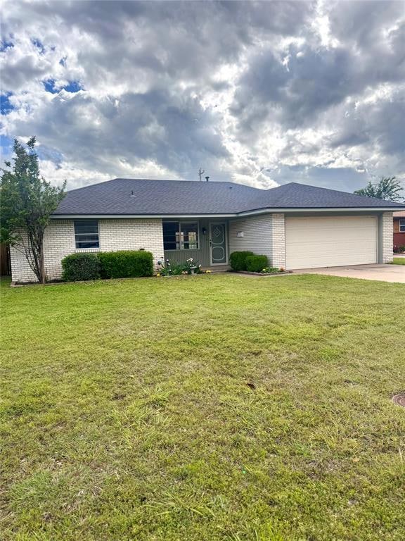 Single story home featuring brick siding, an attac