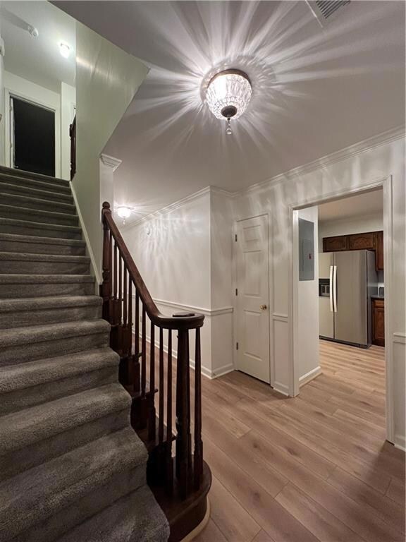 Stairs with wood finished floors, ornamental molding