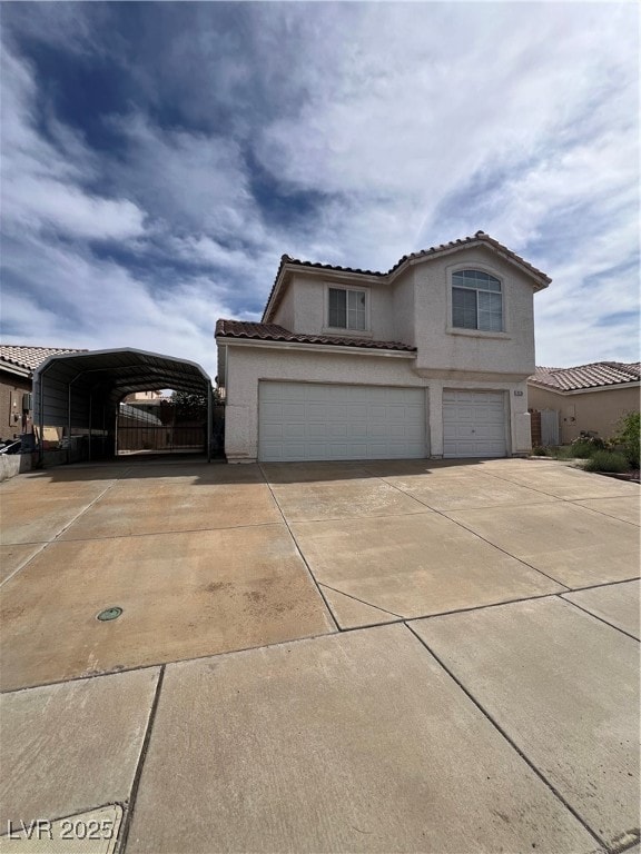 View of front facade with concrete driveway, stucc