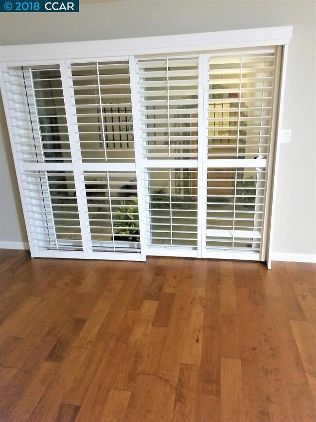 Wooden Shades over dual pane sliding glass door