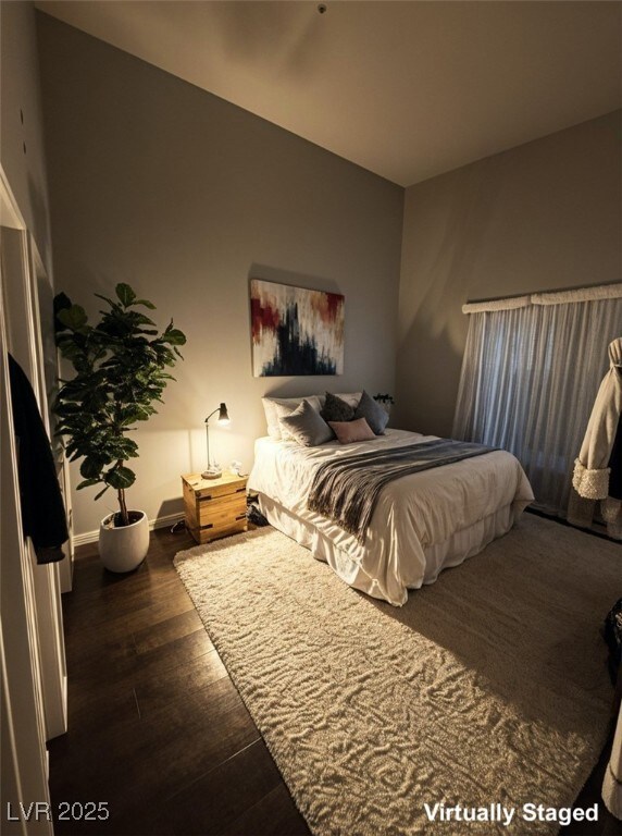Bedroom featuring baseboards and wood finished flo