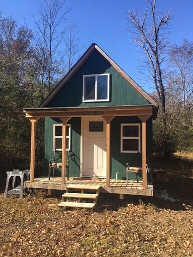 Owner added this framed and roofed outbuilding that future owner could finish. Near Creek