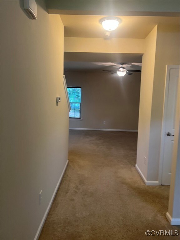 Hall with baseboards and carpet floors