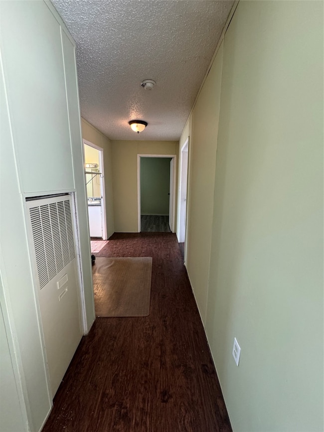 Inviting hallway leading to the bathroom and a bedroom, offering seamless access and privacy.