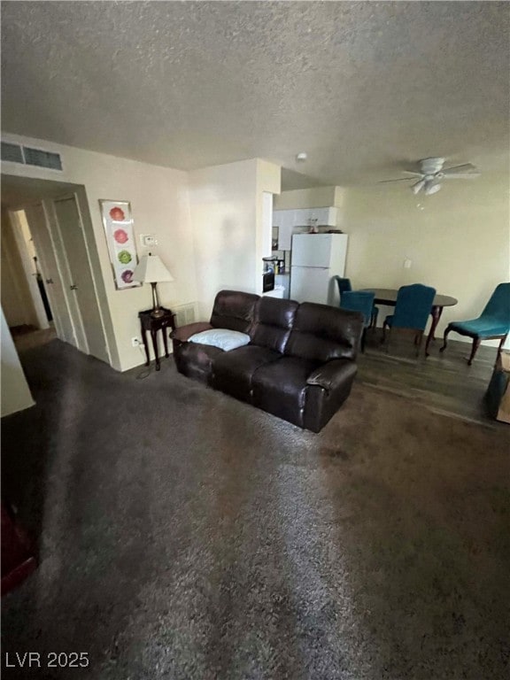 Living area featuring a textured ceiling and a cei