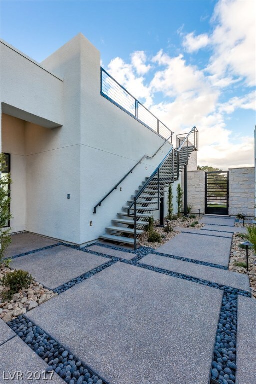 Front courtyard with stairs to amazing rooftop dec