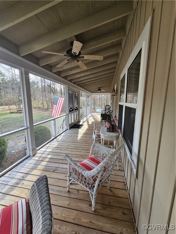 Screen porch with beam ceiling and ceiling fan