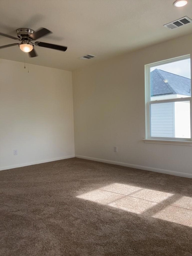 Unfurnished room featuring carpet flooring and ce