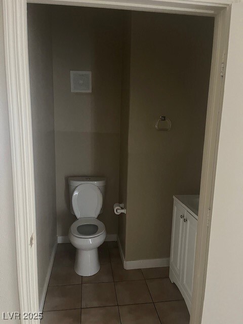 Bathroom featuring tile patterned floors, toilet,