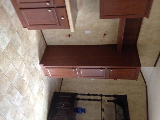 Cherry cabinets, vinyl floors, sunny...