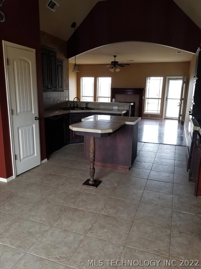 View of kitchen and living room from dining area