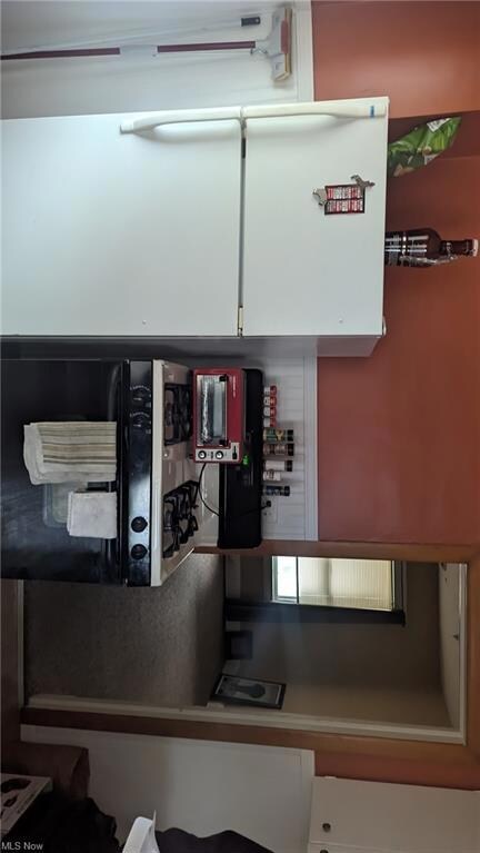 Kitchen featuring white cabinets