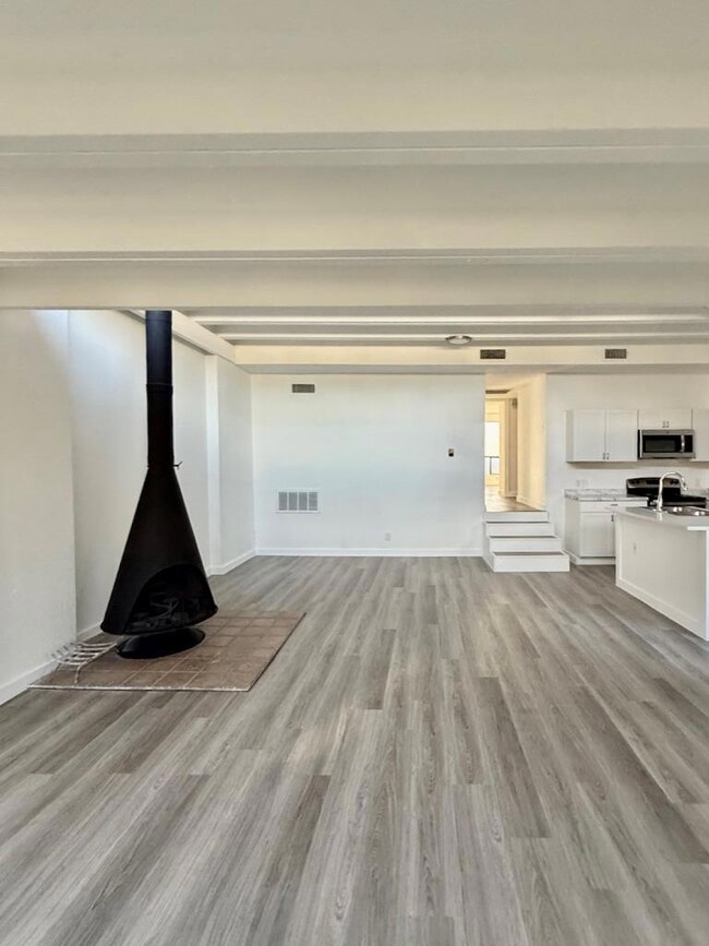 Unfurnished living room featuring light wood-styl