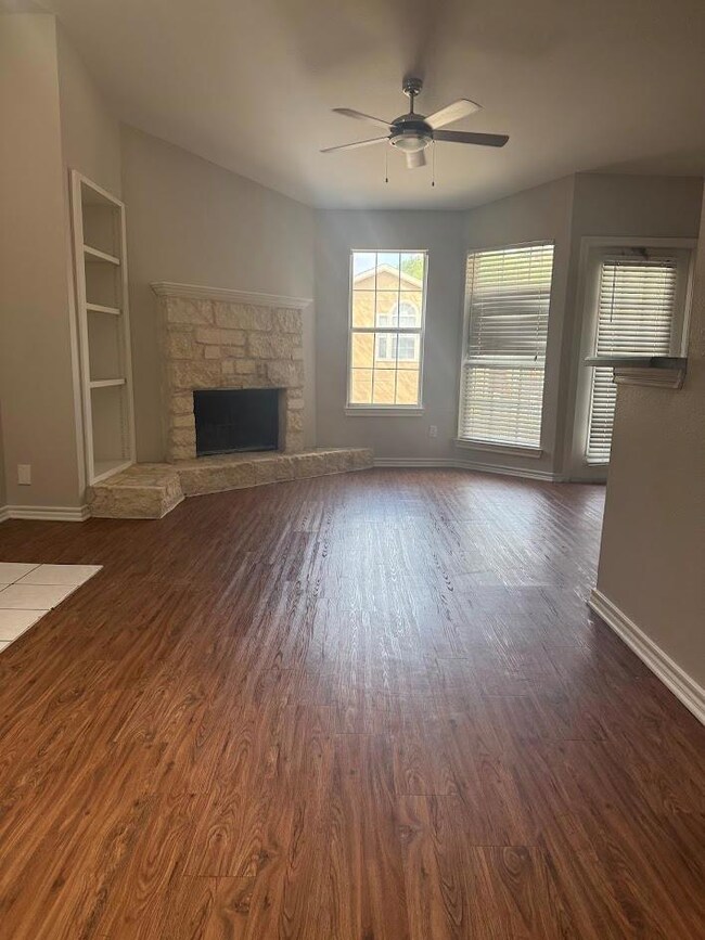 Unfurnished living room featuring a ceiling fan, 