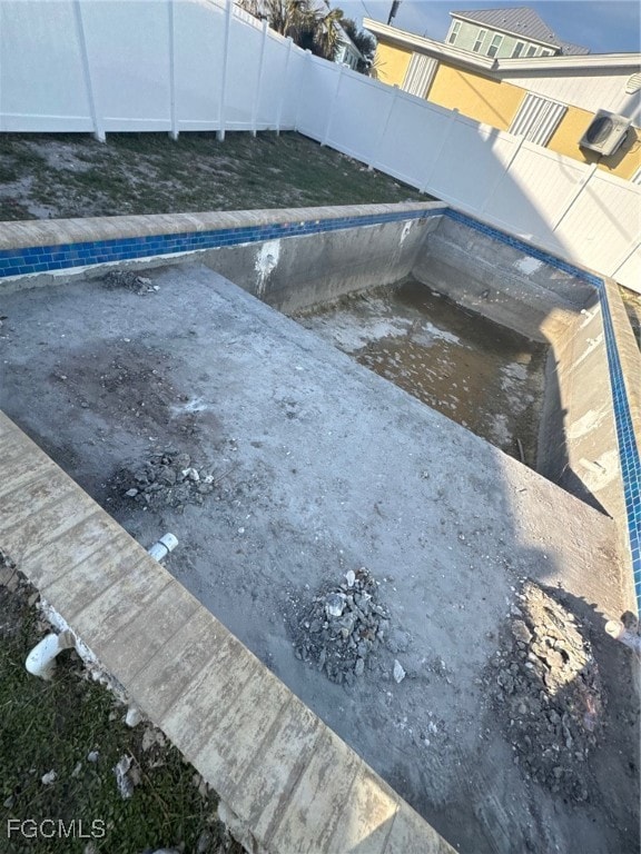 View of pool with a fenced backyard