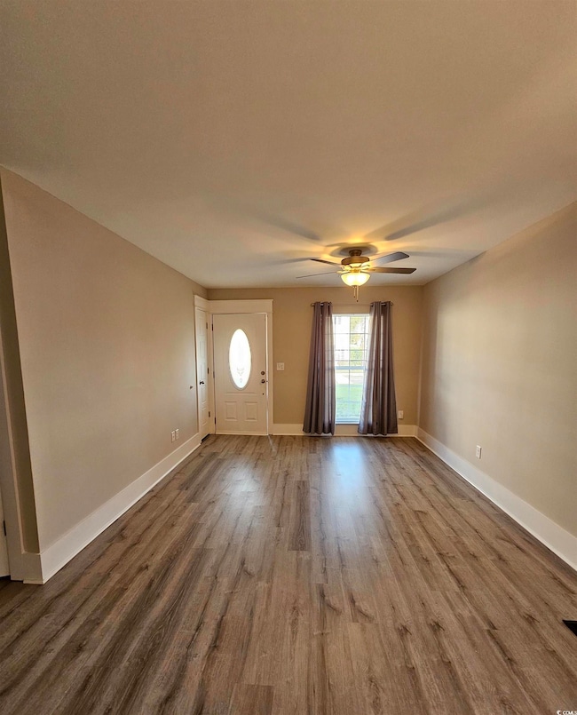 Entrance foyer featuring wood finished floors and ceiling fan