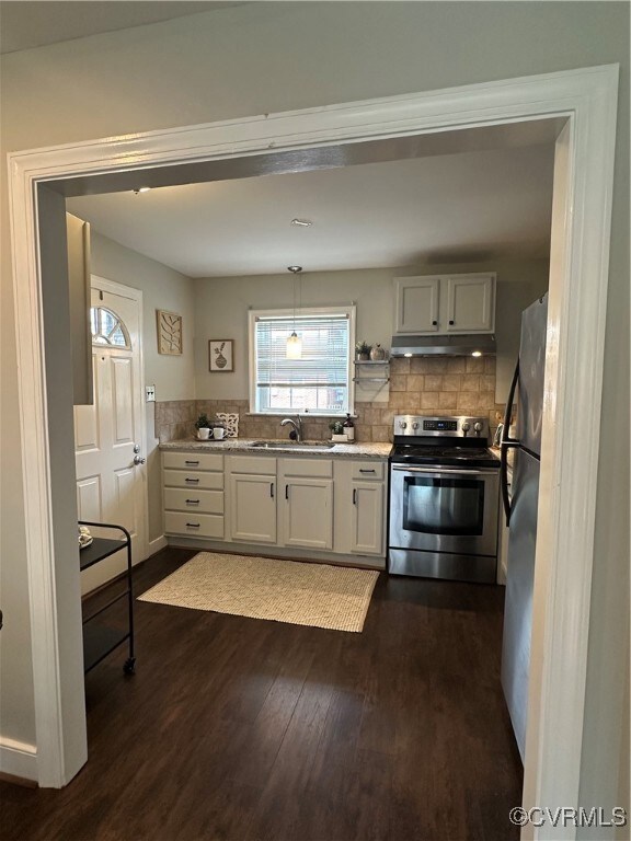 Kitchen with dark wood-style floors, range hood, a